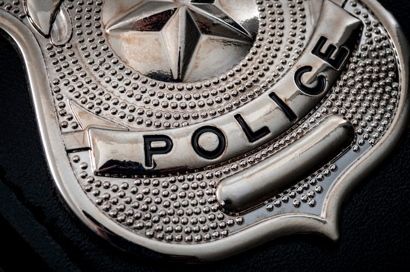 Cops and police officer badge with macro close up on the "police" text of a cop badge