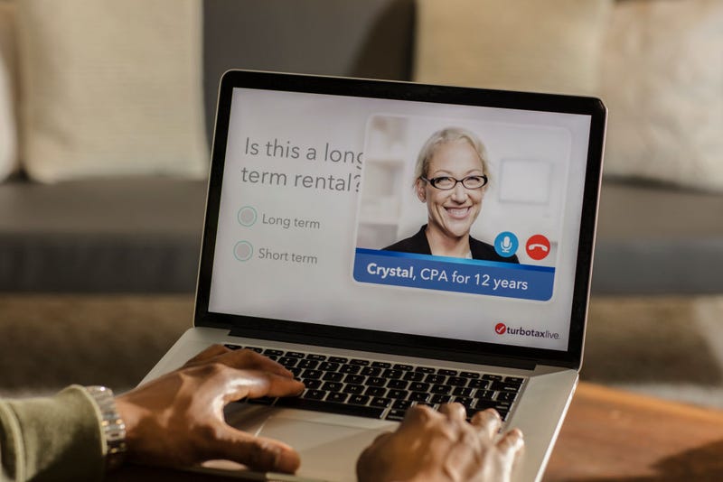 Turbo Tax assistance is displayed on laptop