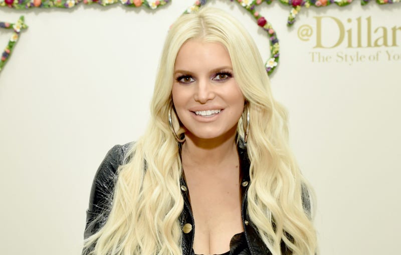 Jessica Simpson signs autographs for fans during a spring style event for army wives and kids
