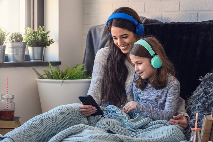 Mom And Daughter Listening To Music