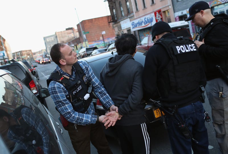ICE agents arrest Mexican immigrants during a 2018 raid in New York City.