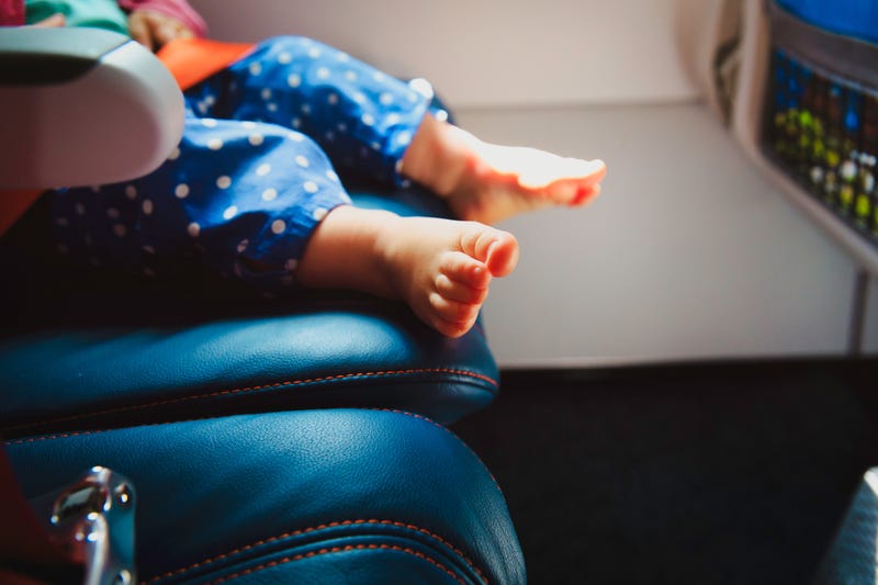 baby feet in airplane seat