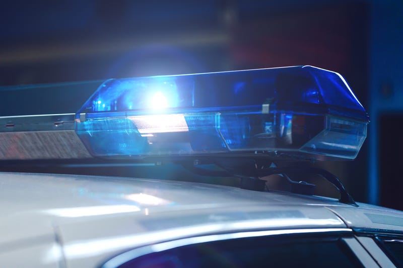 Police at night in the car with blue siren flasher.