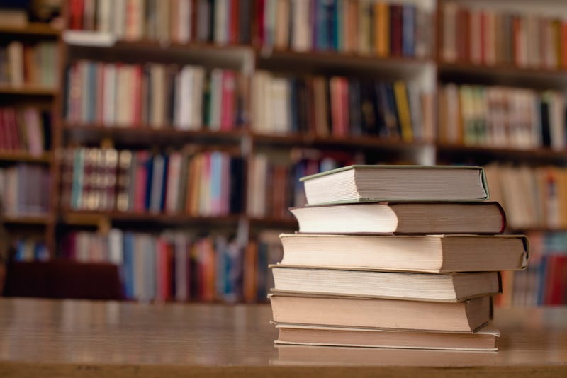 Books on a table in a library.
