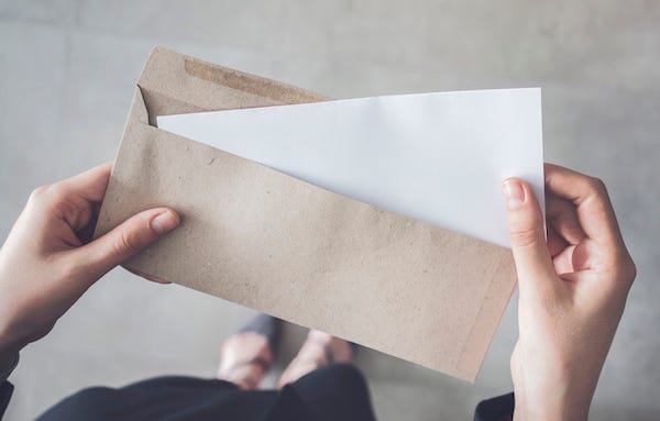 Woman holding a letter in an envelope
