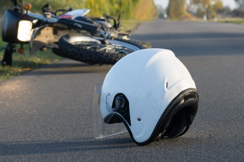 Motorcycle and helmet in road