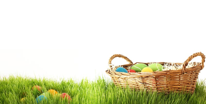 A basket of Easter eggs sitting in the grass