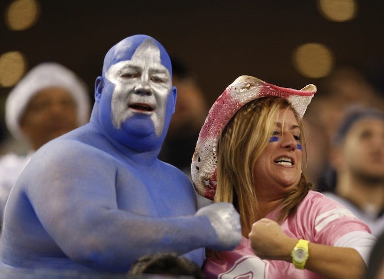 Fans of the Dallas Cowboys cheer from the stands
