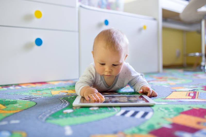 Baby playing on a tablet.