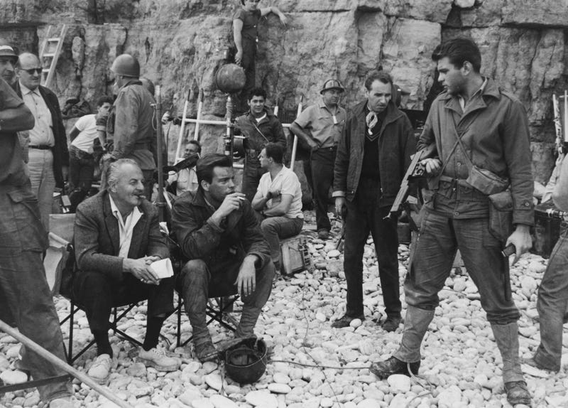 American film producer and screenwriter Darryl F. Zanuck (1902 - 1979, seated, far left) on the set of 'The Longest Day', 6th September 1961. With him are actors Robert Wagner (seated next to Zanuck) and Tommy Sands (far right).