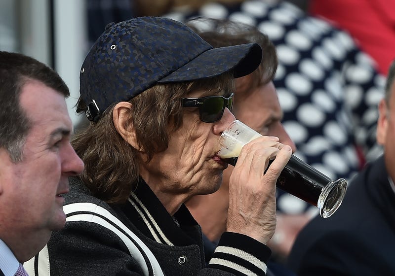 mick jagger drinking a beer