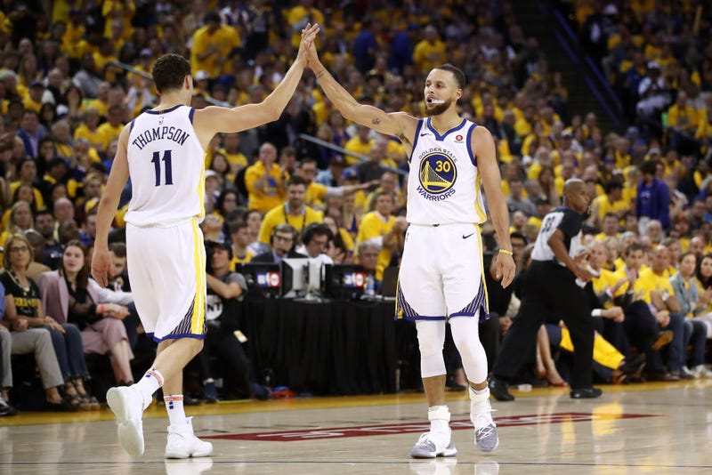 Stephen Curry #30 and Klay Thompson #11 of the Golden State Warriors react after a plat against the Houston Rockets during Game Three of the Western Conference Finals of the 2018 NBA Playoffs at ORACLE Arena on May 20, 2018 in Oakland, California.