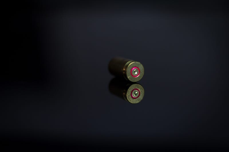 Bullet in shadow on a glass table