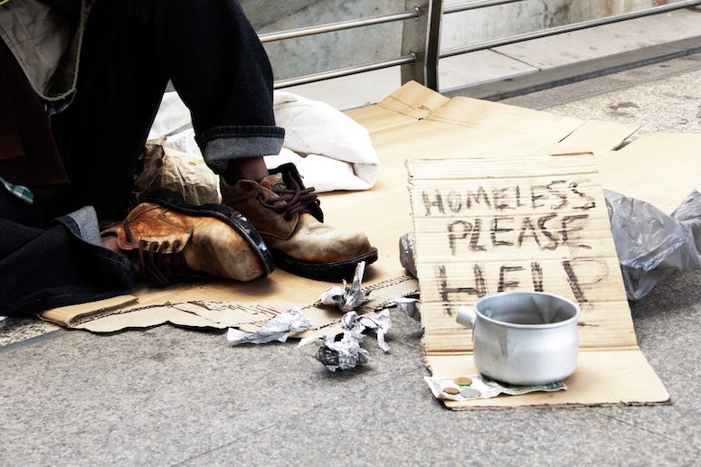 Homeless man asking for donations on street