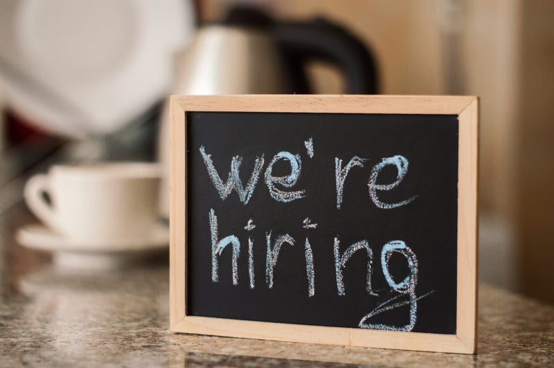 "We're Hiring" sign at restaurant