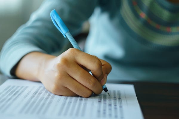 School student answers multiple choice questions during examination