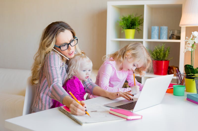 Stock photo of busy mother with kids