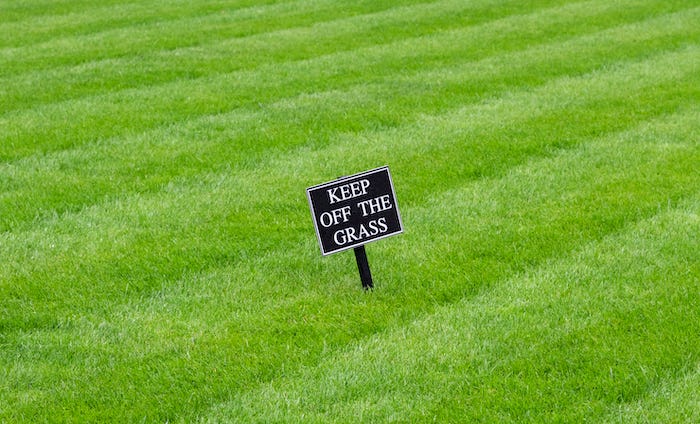 "Keep off the grass" sign on lawn