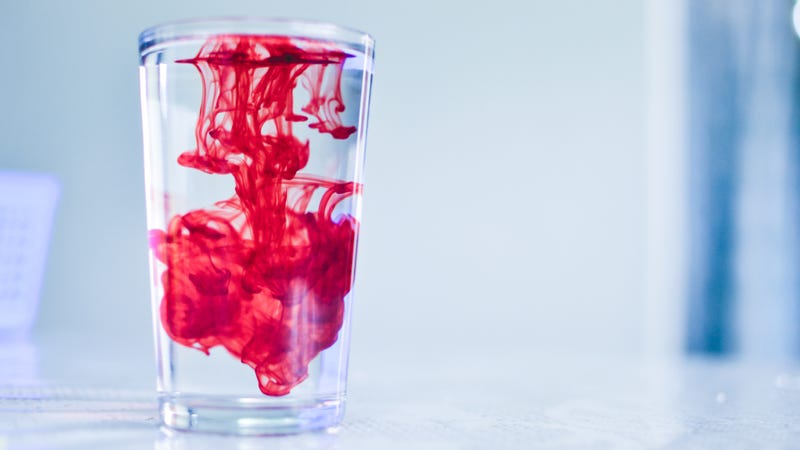 Red dye in a glass of water