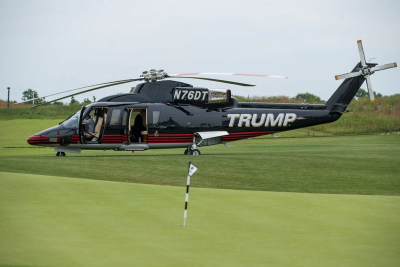 A 'TRUMP' branded helicopter sits near a putting green during a ribbon cutting event for a new clubhouse at Trump Golf Links at Ferry Point, June 11, 2018 in The Bronx borough of New York City.