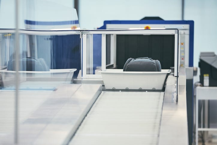 Luggage going through an X-ray machine.