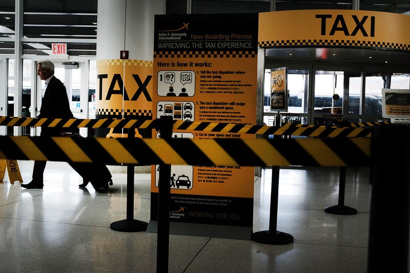 A man walks through an empty taxi line at John F. Kennedy International Airport in New York City.