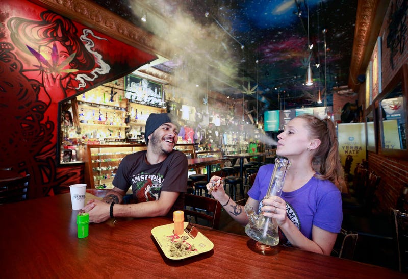 Rodrigo Acevedo Casino looks on as Anna Bolechowska smokes marijuana with a bong at the New Amsterdam Cafe June 20, 2018 in Vancouver, British Columbia, Canada. Canadian Prime Minister Justin Trudeau has announced recreational pot will be legal as of October 17 in Canada. (Photo by Jeff Vinnick/Getty Images)