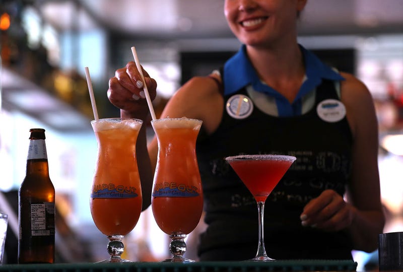 A bartender at Wipeout Bar & Grill makes cocktails that have paper straws on June 21, 2018 in San Francisco, California.