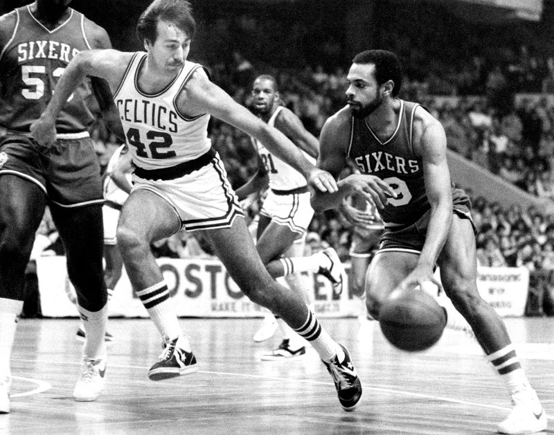 Philadelphia 76ers' Lionel Hollins (right) dribbles the ball as the Celtics' Chris Ford at the Boston Garden on Jan. 8, 1982.