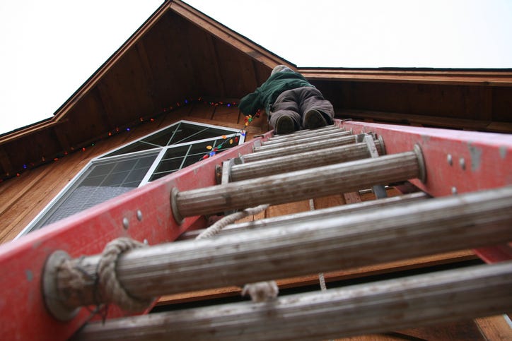 removing Christmas lights with ladder
