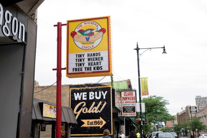 Exterior view of the Wieners Circle hot dog stand (at 2622 North Clark Street) in the Lincoln Park neighborhood, Chicago, Illinois, June 23, 2018. The sign outside reads 'Tiny Hands, Tiny Wiener, Tiny Heart, Free the Kids.' The sign references the supposedly smaller than average sized hands of Donald Trump and his immigration policies that separate parents from their children