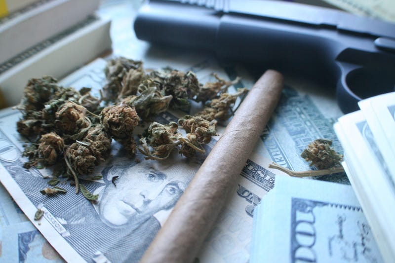 A Detroit man making big money off a vending machine that dispensed marijuana and prescription pills off the side of his house found himself in deeper trouble after police discovered 18 firearms stashed throughout his home.