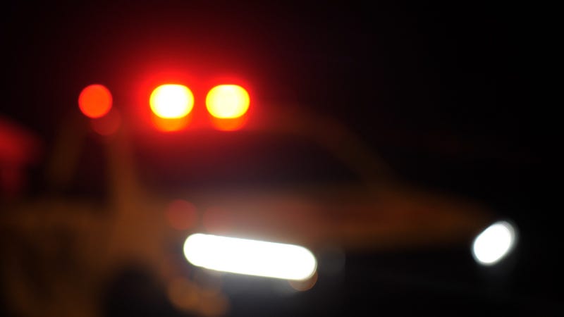 Blurred police car emergency vehicle lights in night street - stock photo