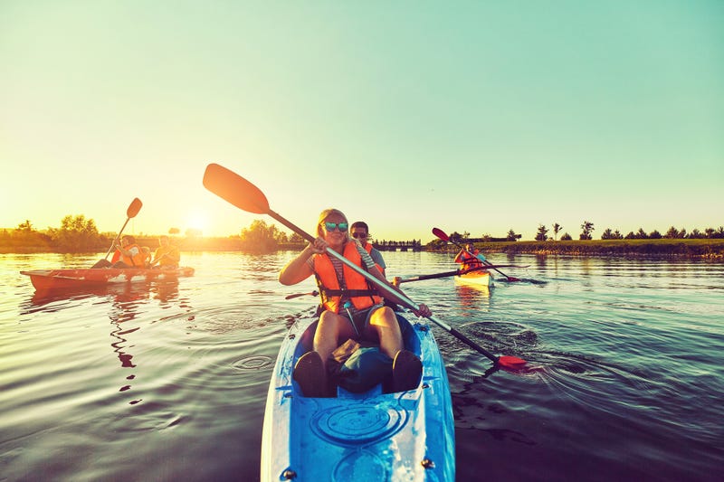 Kayaking and canoeing with family. Children on canoe. Family on kayak ride.