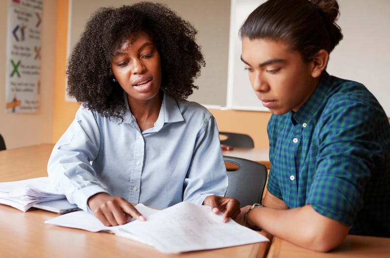 Tutor helping a high school student. 