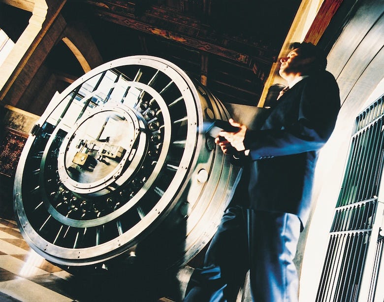 Man walking through a bank vault