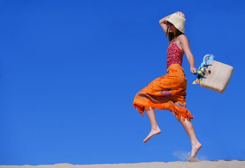 Woman skipping on sand