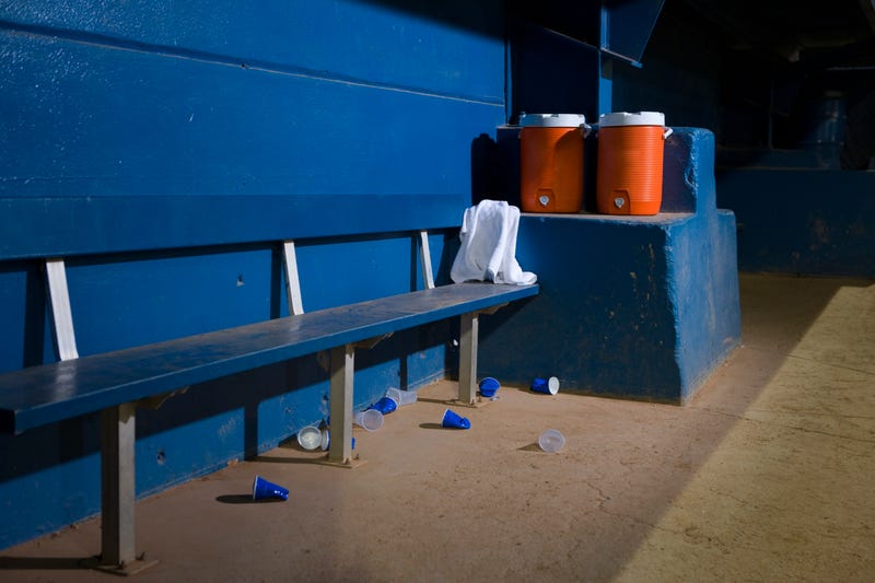 Empty baseball dugout with water coolers