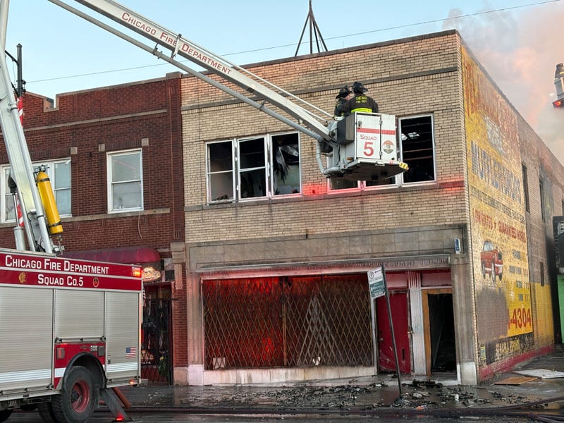 Chicago Firefighters on truck lift at SW Side fire