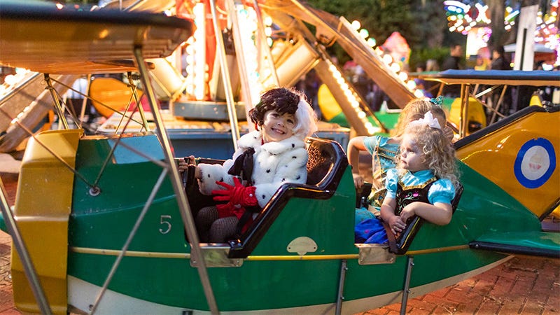 children in costumes on ride