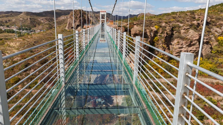 Man clings to railing after glass-bottom bridge shatters under him