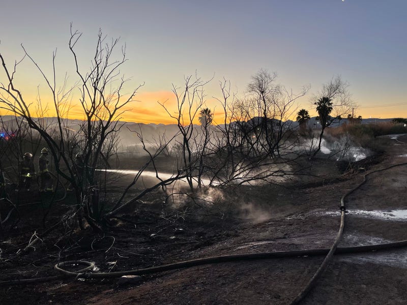 Firefighters extinguish a brush fire in Henderson on January 14, 2026.