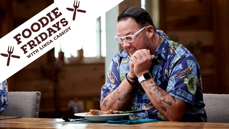 Graham Elliot smiles down at a plate of food