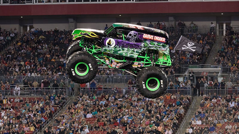 Grave Digger doing jump in front of stadium crowd