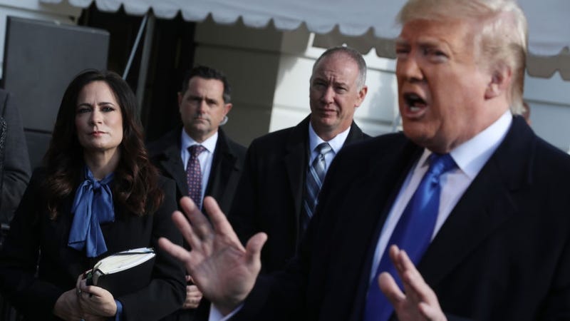 White House Press Secretary Stephanie Grisham (L) listens to U.S. President Donald Trump talk to reporters before he boards Marine One and departing the White House November 08, 2019 in Washington, DC.