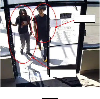 Thomas and Davis entering gun store in Eastpointe