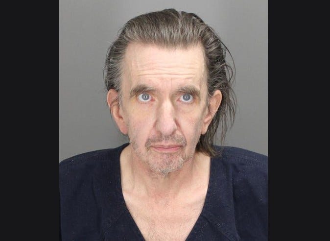 A man who allegedly lived with his roommate's corpse in his bathroom for close to a month in Oakland County has been charged with a misdemeanor for failing to report a deceased person.
