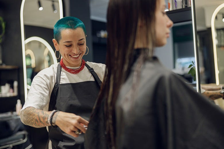 hair stylist cutting woman's hair