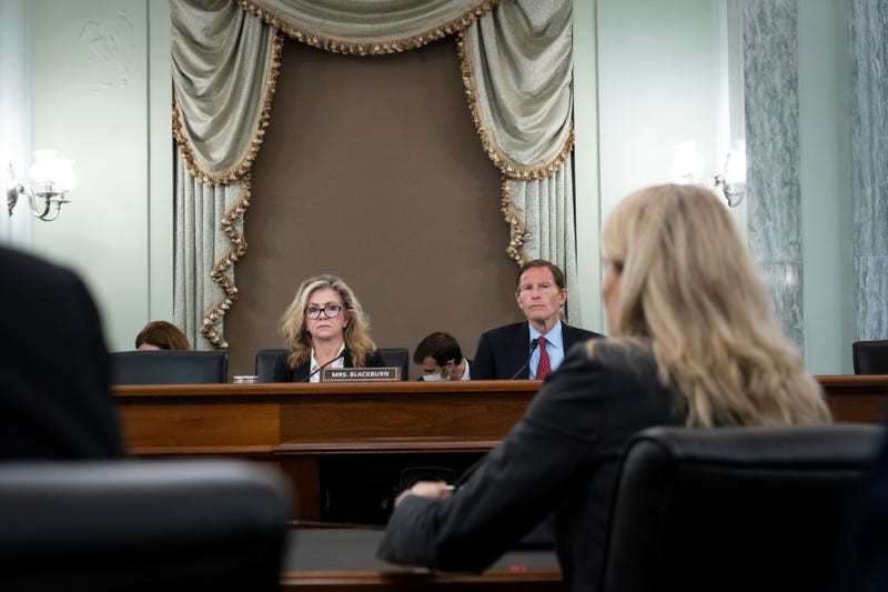 Facebook whistleblower Frances Haugen testifying before a Senate subcommittee, with Sen. Marsha Blackburn (R/TN) and Sen. Richard Blumenthal (D/CT)
