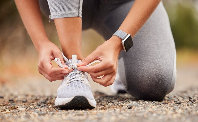 woman lacing sneakers